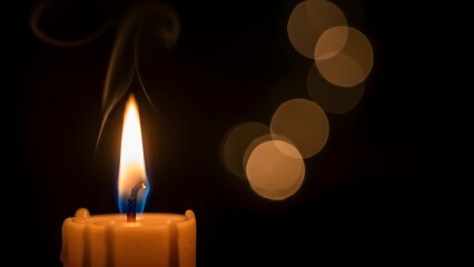 Candles glowing softly in the dark on a black background