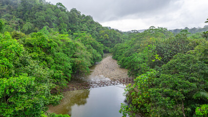 Obraz premium A stunning view of a serene river surrounded by lush greenery in San Cipriano, Buenaventura, Valle del Cauca, Colombia.