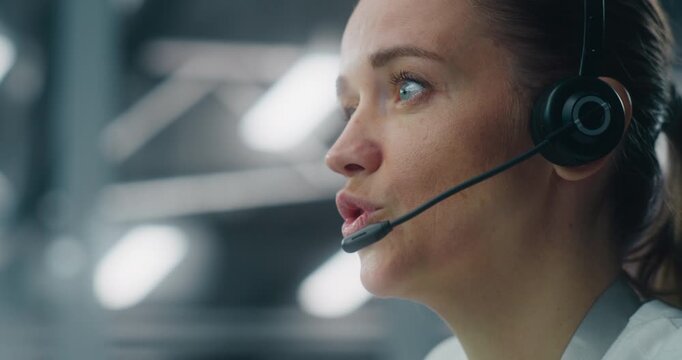 Close Up of Dedicated Female Technician Responding to Real Time System Alerts, Communicating Via Headset at Console in Data Center. Concept of Critical Incident Management and Rapid Response.