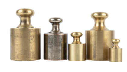 Brass weights lined up, various sizes, worn textures