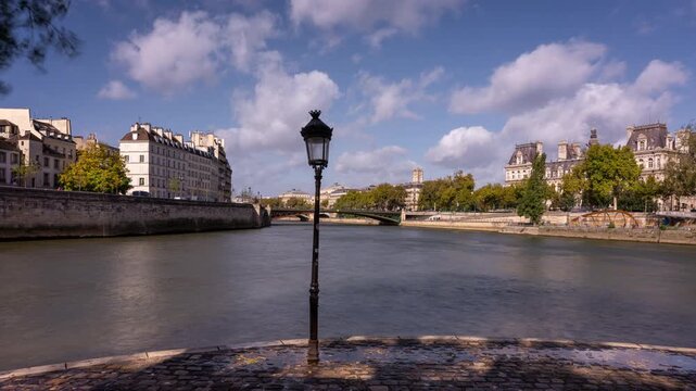 A lamp post near the Seine river in Paris, France with the tourist boats passing by. Timelapse clip