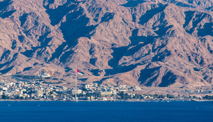 View on the coastal area of Aqaba city with one of the biggest mosque and flag of Arab revolt in Jordan