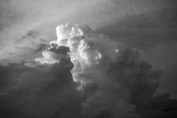 Dramatic black and white fine art photograph of towering cumulonimbus clouds with strong contrast and sculptural light, creating an atmospheric and powerful sky scene