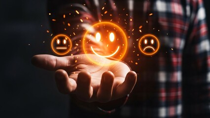 Hand holding glowing smiley face icon with floating happy and sad emoticons representing emotions and mood in a digital or technological context for marketing and advertising purposes