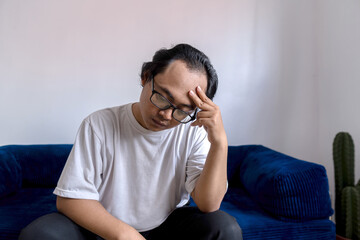 A man holds his head in disappointment over his baldness problem, hair loss treatment, Concept of baldness treatment or hair restoration