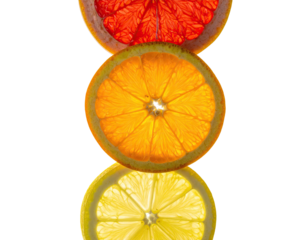 Citrus fruit slices stacked, backlit on black backdrop