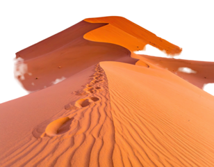Sandy dune slope, footprints leading to the sunlit crest