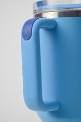 Close-up of a light blue reusable tumbler handle with a dark blue grip, isolated on a white background