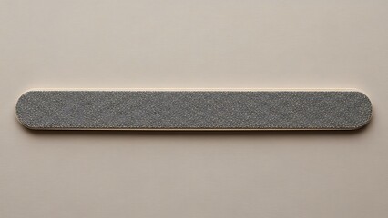 Detailed close-up of nail file on a neutral background, cosmetology tool