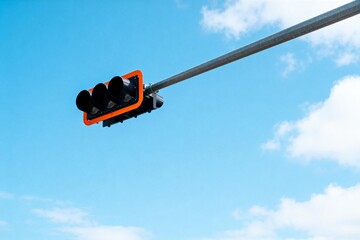 Traffic light against blue sky