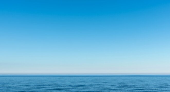 A peaceful wide angle view of the distant blue sky meeting the subtle line of the ocean surface creating a serene natural background texture, template, texture, clean