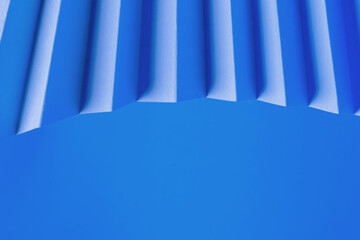 Fototapeta premium Folded blue paper creating a wave-like pattern.