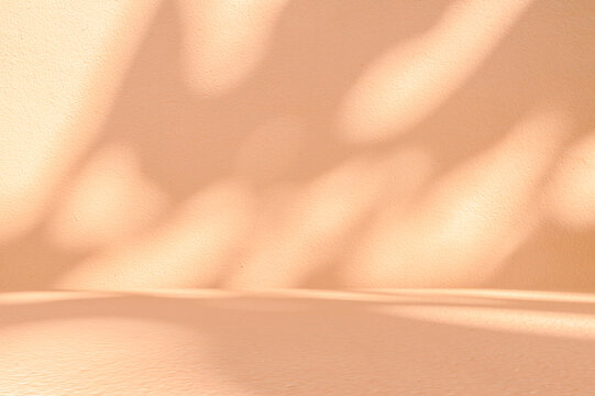 Minimalist Peach Textured Background with Soft Organic Leaf and Tree Shadow Overlays, This minimalist, earth toned backdrop creates a peaceful and natural atmosphere, perfect for beauty product mockup