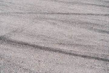Asphalt with black rubber marks from tyres