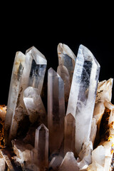 Group of tall natural quartz crystal points with sharp terminations and translucent vertical structures displayed against a solid black background