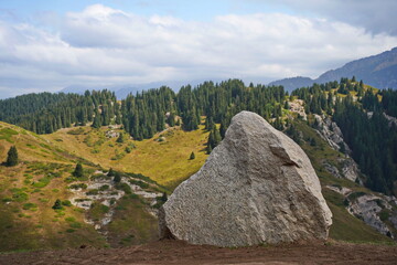 A huge white ak tas stone in the Oi-Karagai mountain gorge.