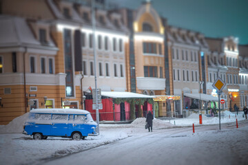 Obraz premium A winter night in Minsk. A car on the street is covered in snow.
