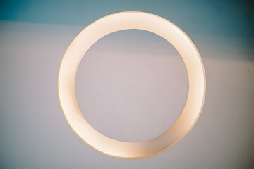 Modern Circular Light Fixture Illuminating a Gradient Background