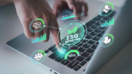 Close up of finger pressing enter on laptop for ESG reporting to finalize sustainability targets and net zero business goals © HappyEva