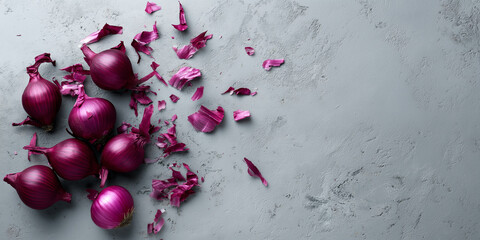 Red onions and purple peels scattered on a gray stone kitchen background, preparing fresh, healthy ingredients