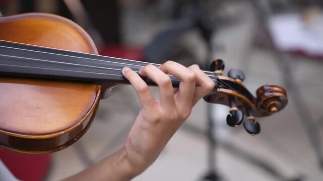 Cinematic Close-Up of Violin Held by Musician During Rehearsal
