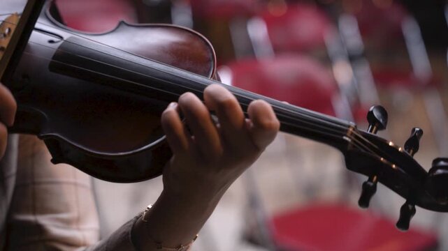 Cinematic Close-Up of Violin Held by Musician During Rehearsal