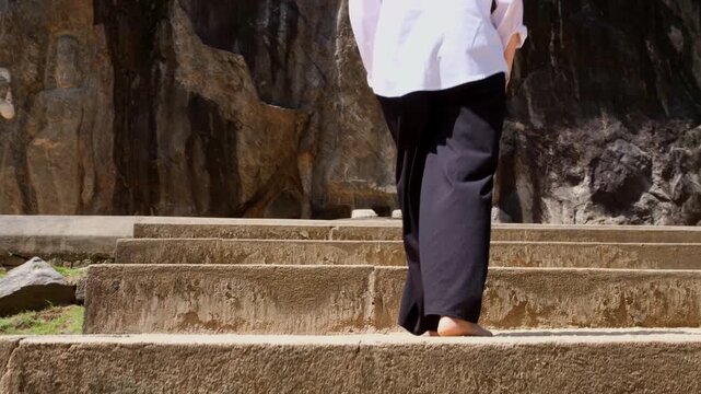 Ancient Buduruwagala rock carvings carved into a cliff in Sri Lanka. Large standing Buddha statues surrounded by tropical greenery, Sacred Buddhist heritage site, spiritual atmosphere and history.