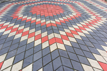 Colorful star shape paving block installation pattern. Painted concrete paving blocks. Paving Floor Surface in red grey and white