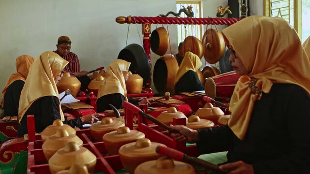 Indonesian women playing traditional javanese gamelan music