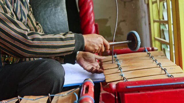Javanese musician playing traditional gamelan music