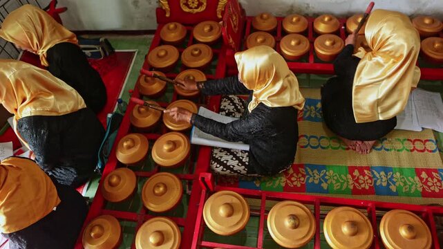 Indonesian women playing traditional javanese gamelan music