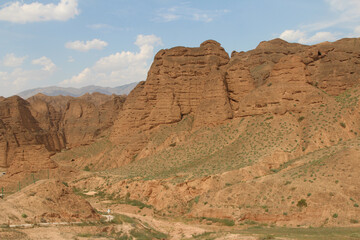 Fototapeta premium Summer scenery of the Yellow River Stone Forest National Geological Park with a woman on hiking path in Jingtai county, Gansu province of China