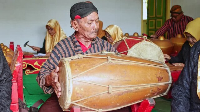 Javanese musician playing traditional gamelan percussion music