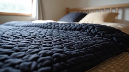 Comfortable Bed With Quilted Cover In Minimalist Bedroom Interior With Natural Light