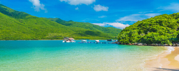 panoramic landscape with a white sandy beach and blue water in a bay of sea on tropical paradise island in an Asian resort in summer