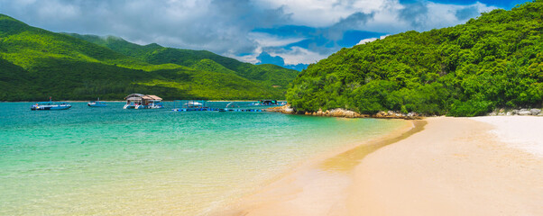 panorama landscape with white sandy beach and blue water in a bay of the sea on tropical paradise island in an Asian resort in summer