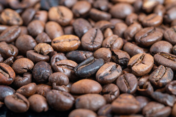 Coffee beans overview, Closeup of medium roasted coffee beans highlighting features, Highresolution image showcasing medium roasted coffee beans with surface oils and textures