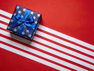 Obraz premium Patriotic American Gift Box with Blue Star Pattern and Ribbon on Red Background with White Stripes perfect for voting day and fourth july celebration