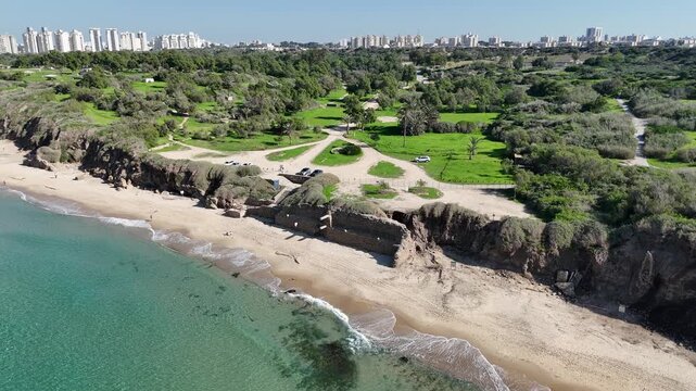 Aerial Drone Side Flight Over Ancient Ruins in Green Park with City Background