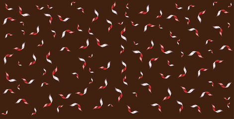 A dark chocolate background covered in swirling red and white candy pieces