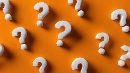White Question Marks on Bright Orange Background Representing Inquiry and Curiosity in a Creative Concept