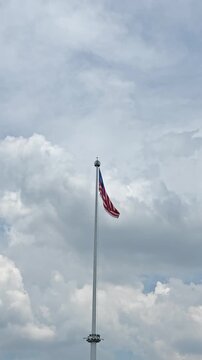 Malaysian flag waving slowly on a flagpole