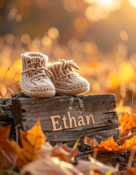 Baby name Ethan engraved on a wooden plaque with knitted baby shoes. Image for baby name reveal