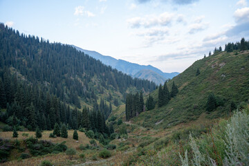 Panoramic mountain landscape of Trans-Ili Alatau range, Almaty, Kazakhstan. Hiking trail to Furmanov and Panorama peaks above 3000 meters in Tien Shan, Central Asia.