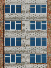 Lviv, Ukraine - 3 4 2020: Facade of a tall multi-storey modern house with balconies and large glass windows. Design of modern architecture. Top view from the bottom. Modern city architecture