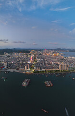 Fototapeta premium Aerial shot of Xinli Building in Shanwei Port, Shanwei City, Guangdong Province, captured at sunset