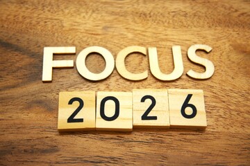 Fototapeta premium Focus 2026 message built from wooden letters on wood material background. Future planning, personal goals, productivity mindset and calendar date strategy concepts.