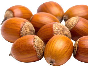 Close-up of several brown hazelnuts in a pile, against a black background