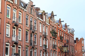 Fototapeta premium Red Brick House Facades in Amsterdam, Bellamyplein Square, Netherlands