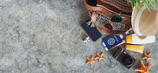 Essential Travel Gear on Grey Concrete Background